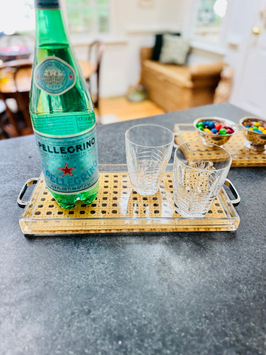 Pellegrino bottle on a tray with glasses and snacks in a casual setting