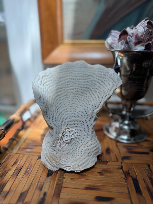 decorative coral structure on brown wooden tray
