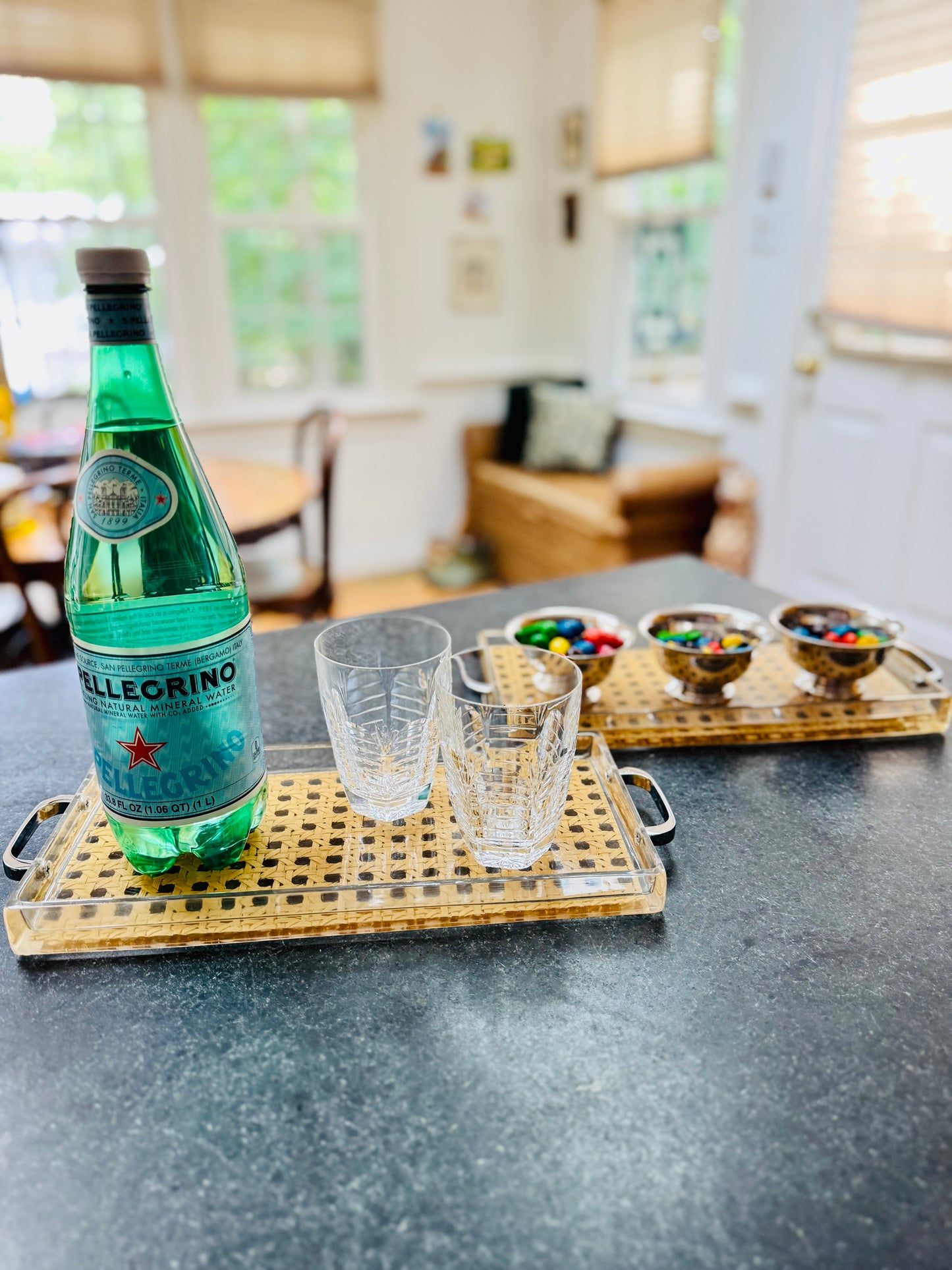 Bottle of Seltzer on a tray with glasses in a kitchen setting