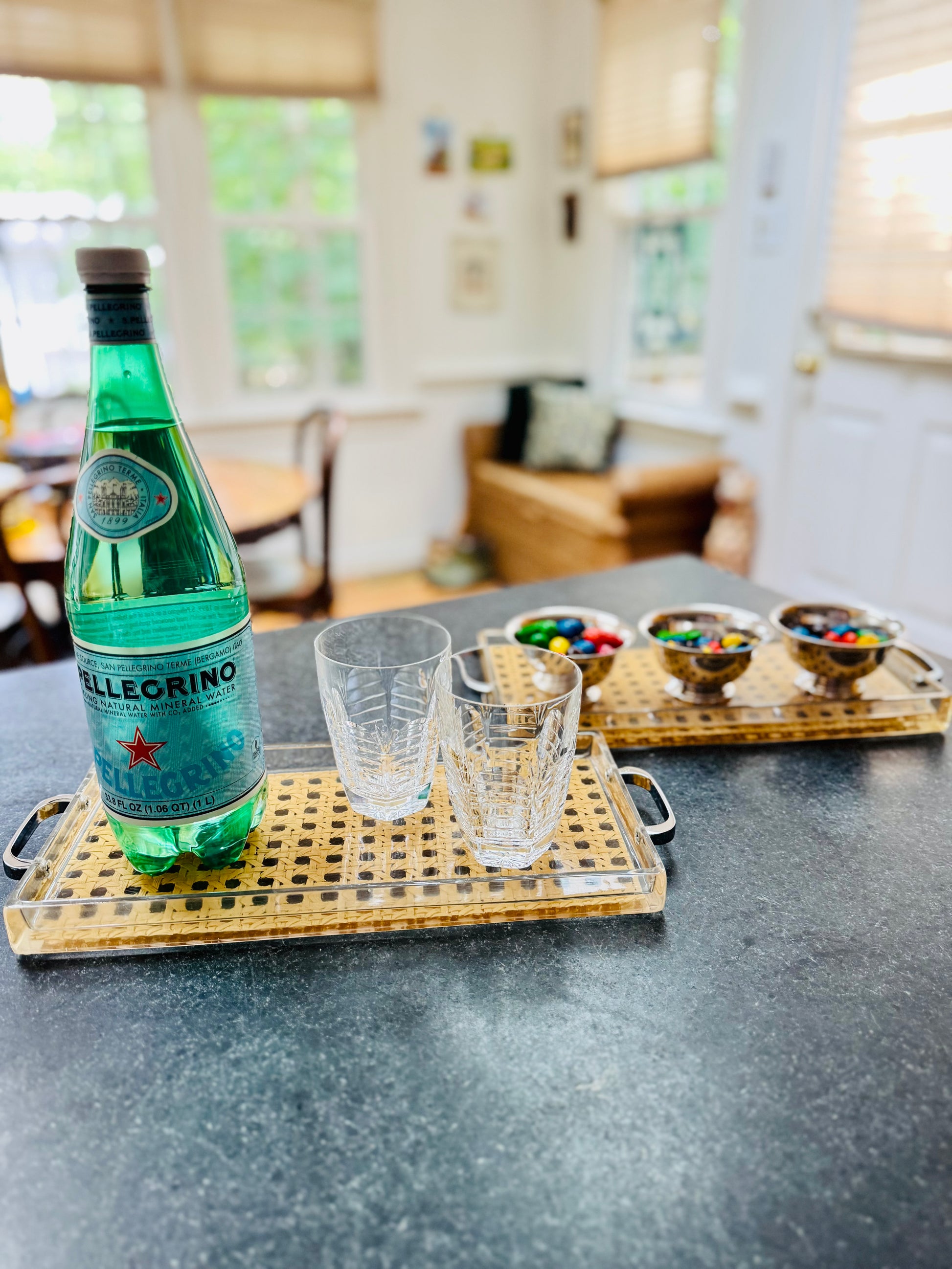 Bottle of Seltzer on a tray with glasses in a kitchen setting
