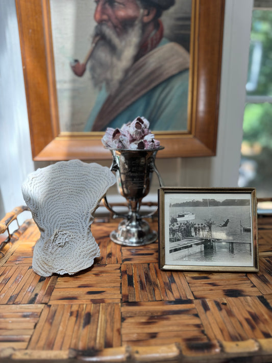 Decorative items on a wooden table with a framed picture in the background