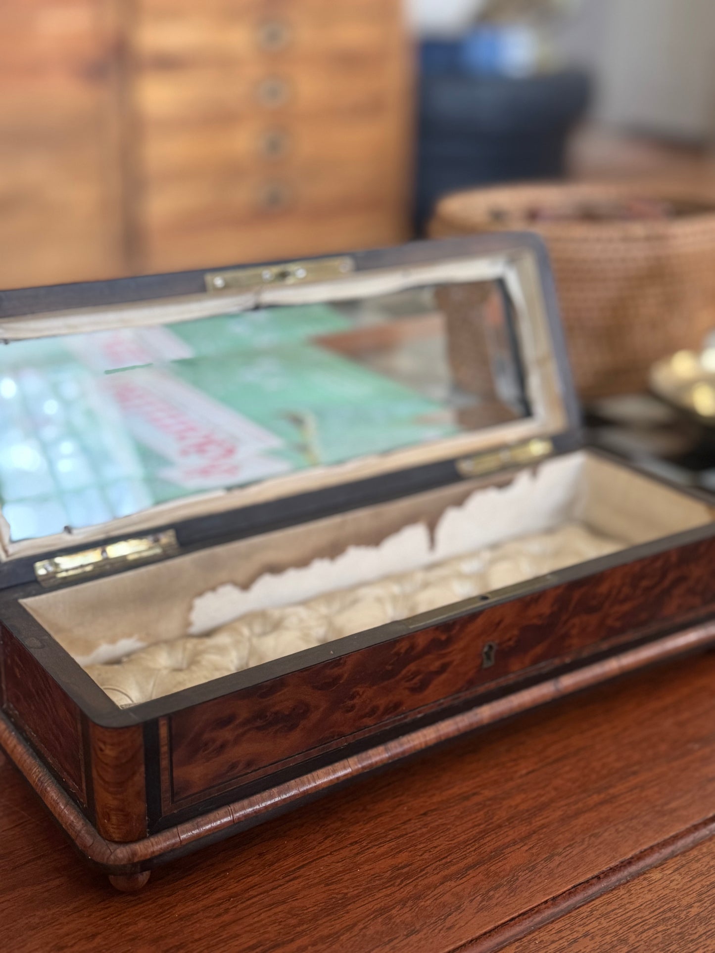 Wooden jewelry box with a mirror lid on a wooden surface