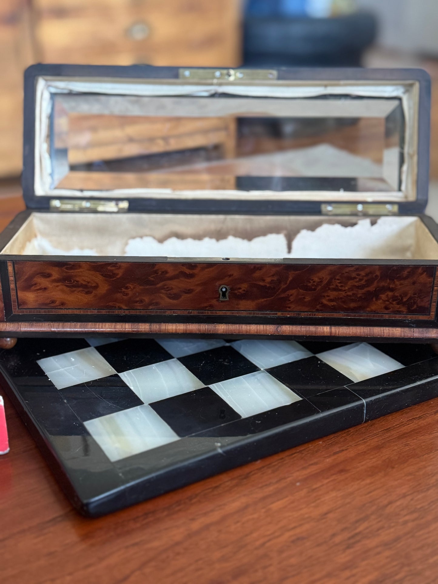 Wooden chessboard with checkered pattern on a wooden surface