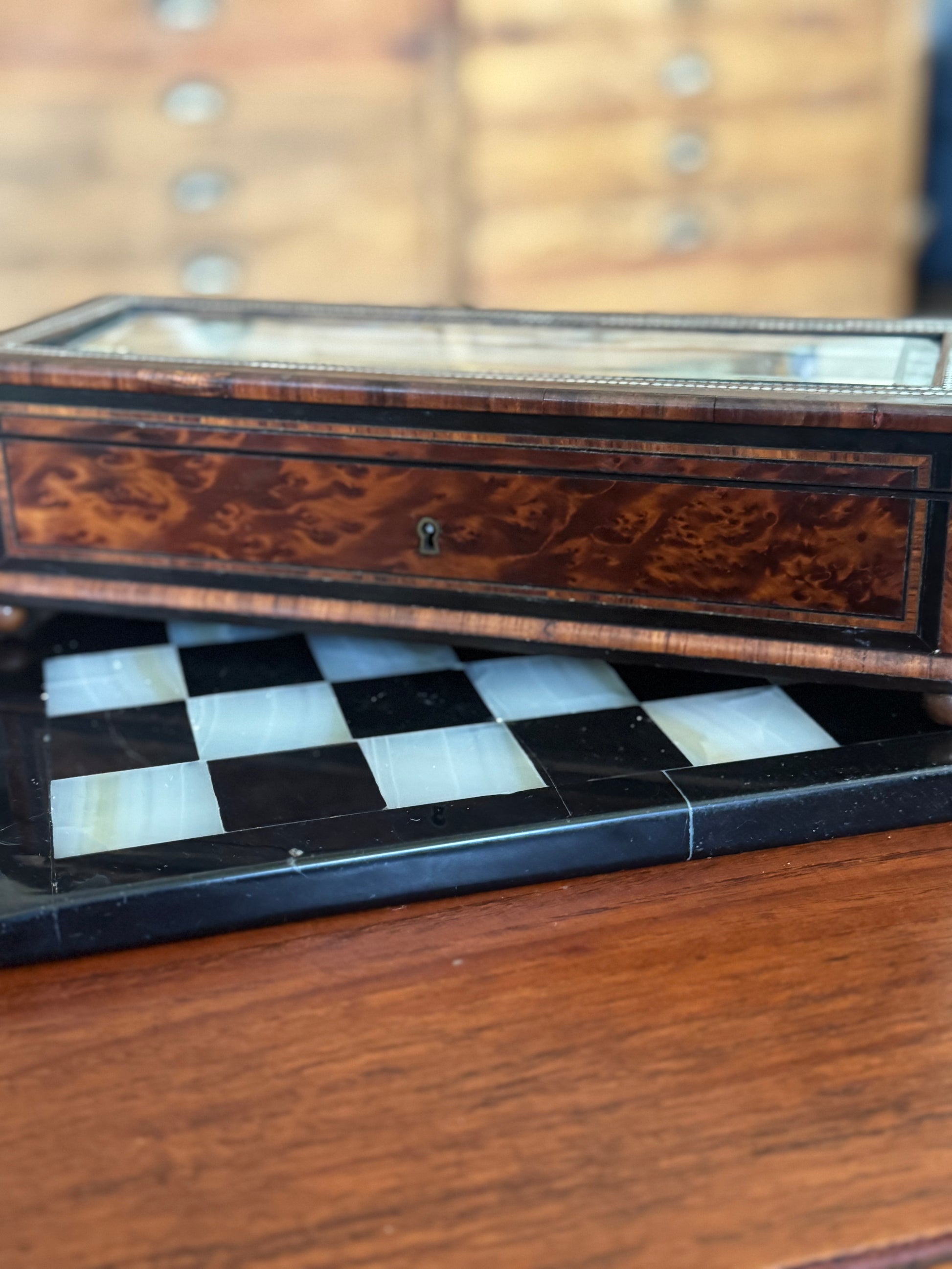 Wooden chessboard with checkered pattern on a wooden surface