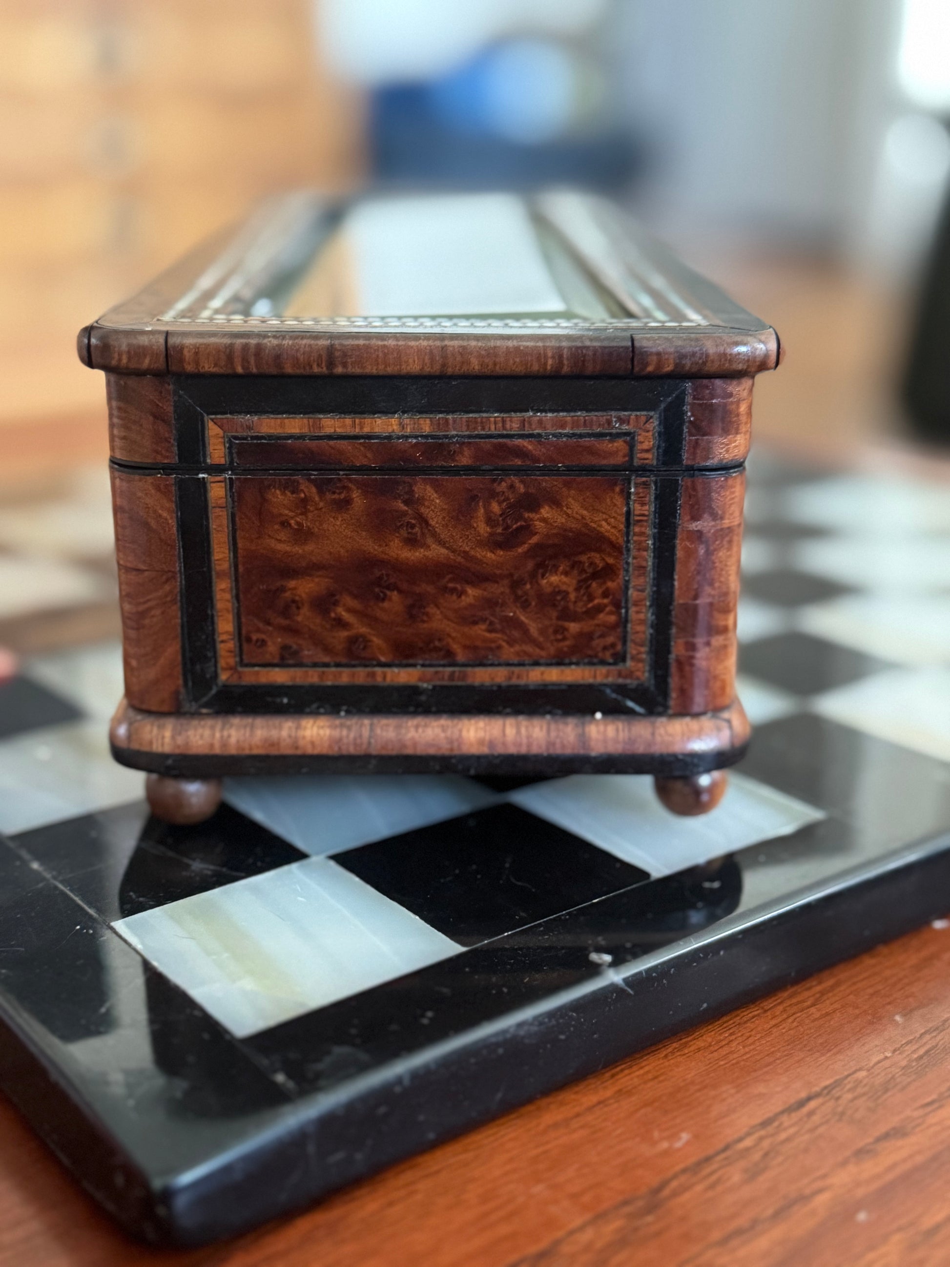 Wooden jewelry box on a checkered surface